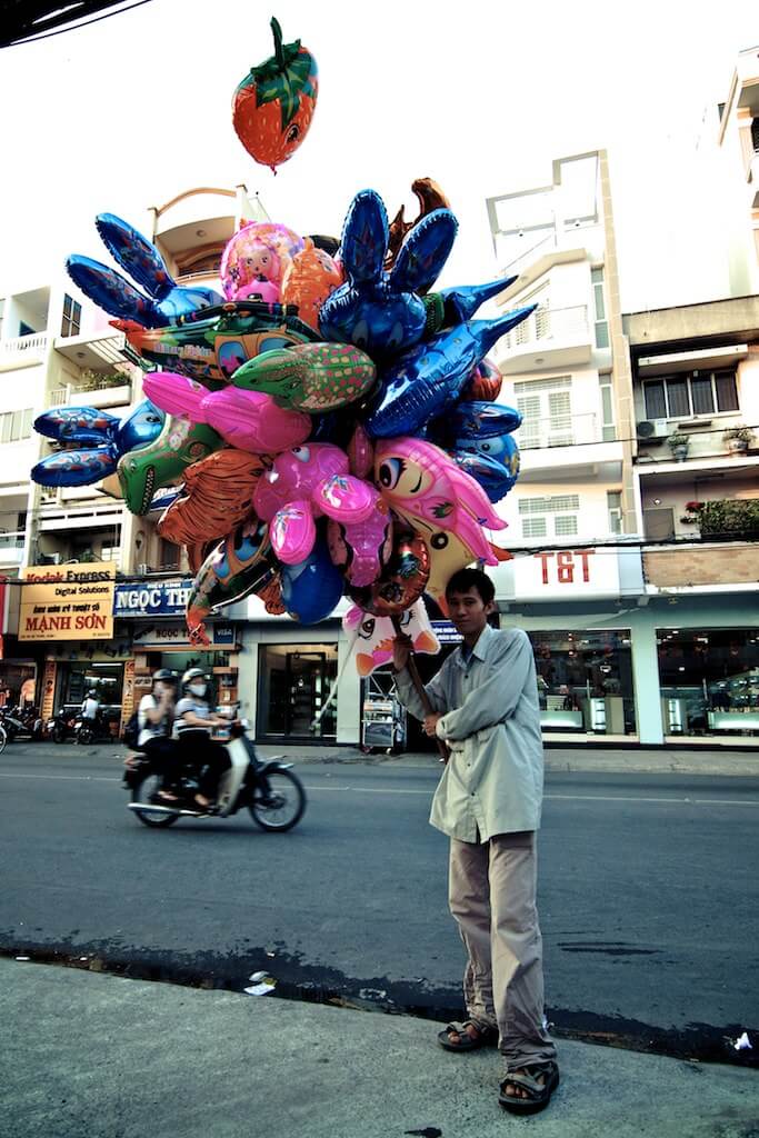 Balloon sellers often look as if they are ready to take off with their large bunches of shaped balloons